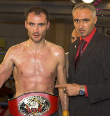 Ian Young (left) with  WKN world president Stephane Cabrera winning his British title.