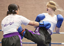 Jennifer Rainey lands a half turning kick to Angie McCurrie