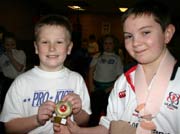 Lewis guy is presented with his winners trophy by black belt Christopher Bryans 