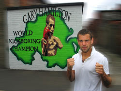 Gary Hamilton stands proud beside his gable-end mural