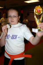 Roxanne Christie wins a trophy for best Orange belt technique 