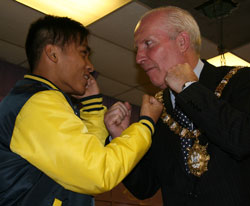 Lord Mayor Clr Jim Rodgers squares up with one of the Hong Kong Boxers