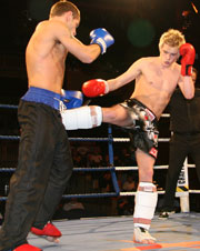 Lisburns Mark Bird lands a kick to Gary Hamilton