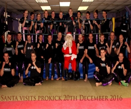 Kris Kringle known as Father Christmas was at the ProKick Gym in Belfast - first-up he visited the kicking mad Kids and stayed on to watch the adult competition .