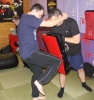 wo of ProKick's boot camp-ers working hard on knee strike techniques