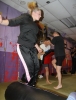 ProKick member Christine Miller jumping high over the bag obstacle