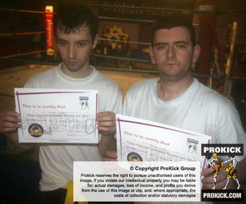 Two new Orange belters Mark And Adrian - A grading is when Kickboxing students, non-contact and contact, are assessed through a series of levels / grades, with the base level being White Belt