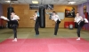 Saskia Connolly, Leith Braiden, Jamie Phillips and Kyle Morrison practicing their roundhouse kick techniques on day 2 of their Junior Black Belt grading.