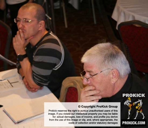 Deep in thought – Officials L-R WKN Swiss Rep and Former World champion Mr Carl Emery with senior WKN-UK Official (ENG) Mr Bob Hunter.
