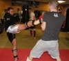 ProKick fighter Kris Hanna throwing a roundhouse kick in sparring class