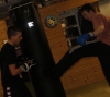 ProKick novice fighter Steven Forde holding the heavy bag for one of his boot-camper team mates