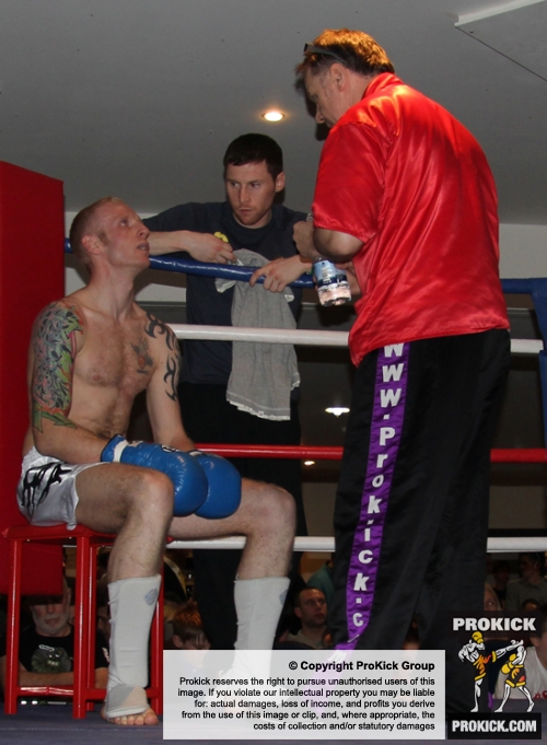 ProKick's Darren McMullan listens in to coach Billy Murray during his K1 style match on 25th February 2012 in Staines, Essex.
