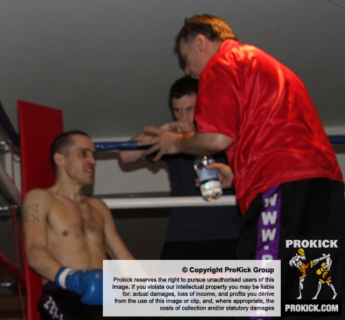 ProKick's Davy Foster listens to coach Billy Murray after round 2 with opponent Scott Bryant on 25th February 2012 in Staines, Essex.