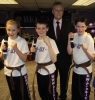 Saskia Connolly, Jamie Phillips and Kyle Morrison show off their new Black Belts presented to them by Northern Ireland First Minister Peter Robinson.