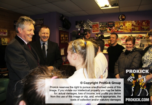 ProKick founder and head coach Billy Murray introduces the Northern Ireland First Minister to the four Junior Black Belt recipients.