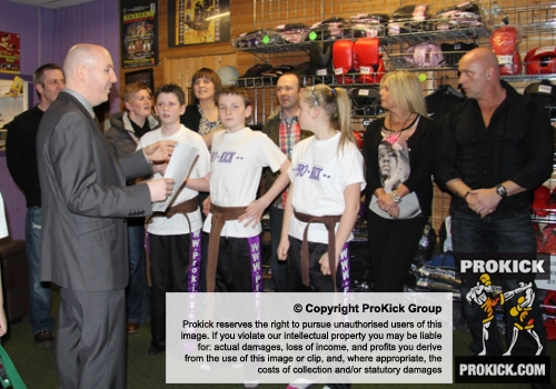 The new ProKick junior Black Belts and their proud parents ready themselves to greet the First Minister on his visit to ProKick HQ.