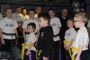 ProKick junior members watch on as Northern Ireland First Minister Peter Robinson presents 4 team mates their Black Belts