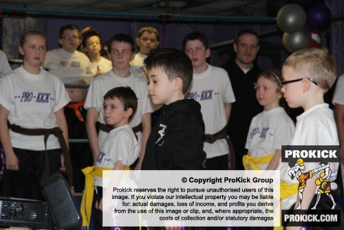 ProKick junior members watch on as Northern Ireland First Minister Peter Robinson presents 4 team mates their Black Belts