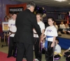 Northern Ireland First Minister Peter Robinson presents ProKick's 'Fab Four' with their Black Belts.