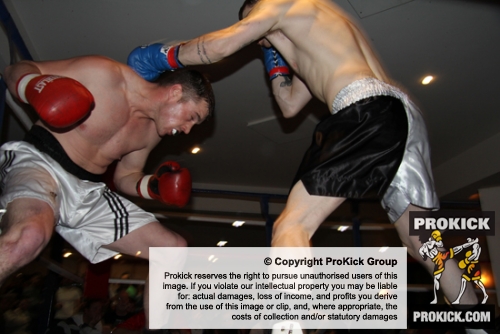 ProKick's Johnny Smith narrowly misses with a big hook during his first competitive boxing match on 25th February 2012 in Staines, Essex.