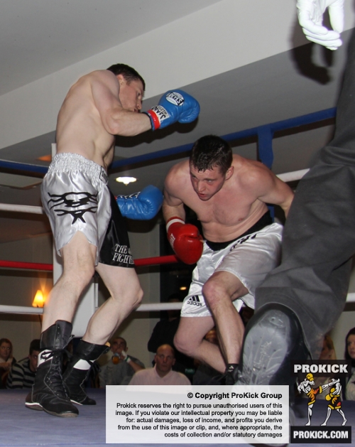 ProKick's Johnny Smith lands another body shot during his first competitive boxing match on 25th February 2012 in Staines, Essex.