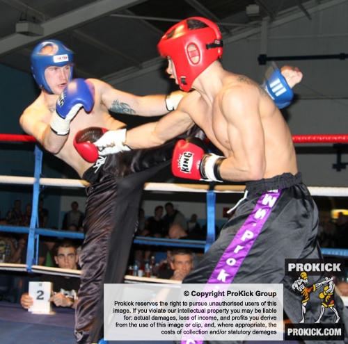 ProKick's Karl McBlain countering a hard roundhouse kick from England's Dean Petty