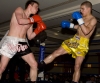 Mark Bird takes a low kick in an Oriental rules K1 Style 4x2 match with Kevin Eiberg (Germany)
