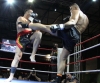 Jerome Le Banner landing a hard roundhouse kick to the torso of Stefan Leko