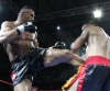 Jerome Le Banner thunders a hard body kick towards Stefan Leko