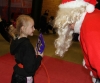 Santa Claus gives a selection box to Chloe Hagan