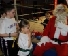 Santa Claus gives out a selection box to Kirsti Foster