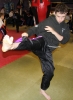 ProKick junior competitor Bailie 'Clubber' McClinton throwing a hard roundhouse kick in his Junior Blue Belt grading
