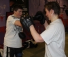 One of ProKick's beginner kickboxing enthusiasts working hard with a member of the senior class