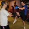 One of ProKick's beginner kickboxing enthusiasts working hard with a member of the senior class.