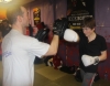 One of ProKick's beginner kickboxing enthusiasts working hard with a member of the senior class.