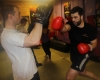 One of ProKick's beginner kickboxing enthusiasts working hard with a member of the senior class.