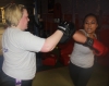 One of ProKick's beginner kickboxing enthusiasts working hard with a member of the senior class.