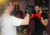 One of ProKick's beginner kickboxing enthusiasts working hard with a member of the senior class.