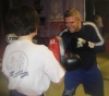 One of ProKick's beginner kickboxing enthusiasts working hard with a member of the senior class.