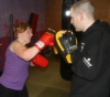 One of ProKick's beginner kickboxing enthusiasts working hard with a member of the senior class.