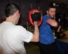 One of ProKick's beginner kickboxing enthusiasts working hard with a member of the senior class.
