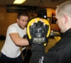 One of ProKick's beginner kickboxing enthusiasts working hard with a member of the senior class.