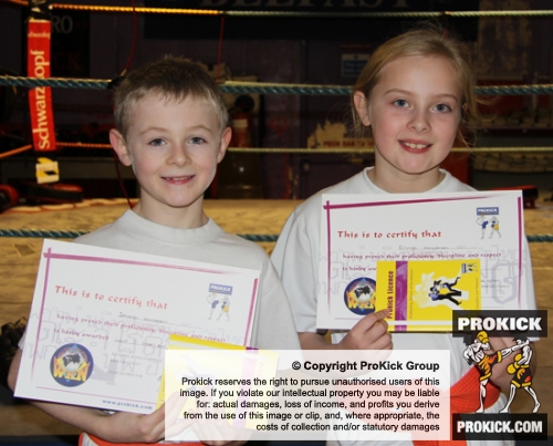 New ProKick Junior Green Belts (also brother and sister) Emma and Jonathan Henderson celebrate together