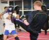 Michael O'Neil and team were offered an opportunity to come together with Kickboxing group J-Network. Michael throws a high kick to a Japanese fighter.