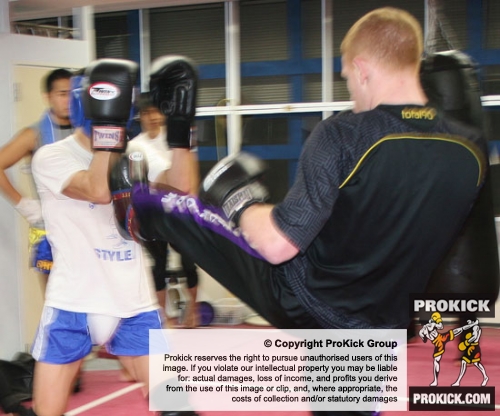 Michael O'Neil and team were offered an opportunity to come together with Kickboxing group J-Network. Michael throws a high kick to a Japanese fighter.