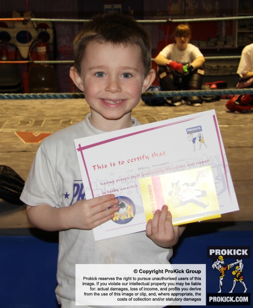 New ProKick Junior Yellow Belt Adam McConnell smiling with pride after a hard grading day at ProKick HQ