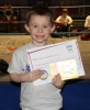 New ProKick Junior Yellow Belt Adam McConnell smiling with pride after a hard grading day at ProKick HQ