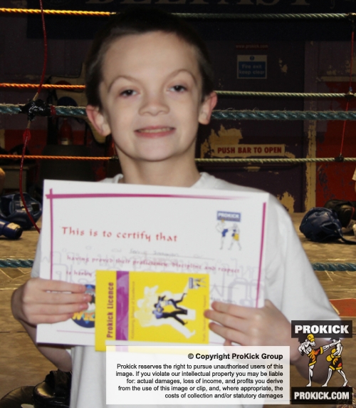 New ProKick Junior Yellow Belt Ferris Stephenson smiling with pride after a hard grading day at ProKick HQ