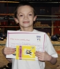 New ProKick Junior Yellow Belt Ferris Stephenson smiling with pride after a hard grading day at ProKick HQ
