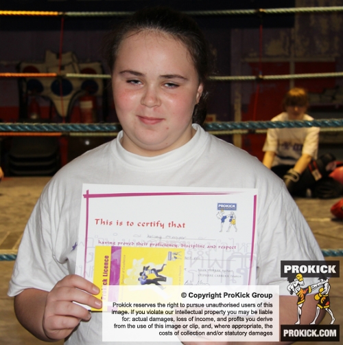 New ProKick Junior Yellow Belt Kelsey McAllister smiling with pride after a hard grading day at ProKick HQ
